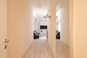 a hallway leading to a living room with white walls at Grazioso Appartamento Trastevere in Rome