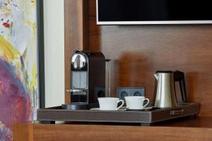 a tray with two cups and a coffee maker at JW Marriott Hotel Frankfurt in Frankfurt