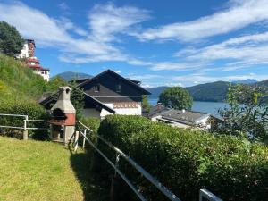 a house on a hill next to a body of water at See- & Bergblick Millstatt in Millstatt