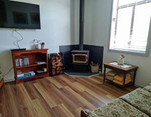 a living room with a wood stove in a room at Millhouse on Pine in Pemberton