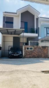 a large house with a driveway in front of it at Nata Villa Syariah close to Telkom in Bandung