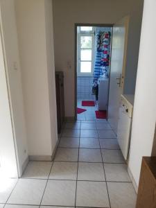 a hallway with a tile floor in a house at Apartment White, Wohnung in Altenstadt