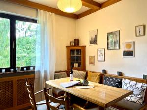 a dining room with a wooden table and a window at Haus mit Garten in Eugendorf