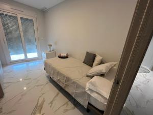 Un dormitorio blanco con una cama y una ventana. en TERRAZA LA MARINA, en Elche 8 fotos más