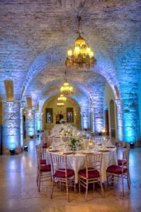 a dining room with a table and chairs in a building at Mir Amin Palace in Beït ed Dîne