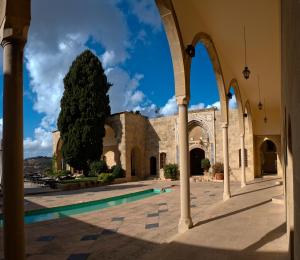 a view of the courtyard of a building with a tree at Mir Amin Palace in Beït ed Dîne