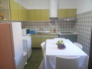 a kitchen with a table with a bowl of fruit on it at River City House 