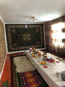 Zimmer mit Tisch und Essen drauf in der Unterkunft Song Kol Flex Travel guests house in Dzhangyaryk