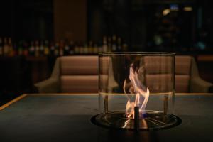 a glass on a table with a fire in it at Akiu Fuga in Sendai