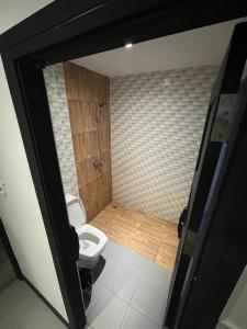 a bathroom with a toilet and a shower at Islanda Hotel Patong in Patong Beach