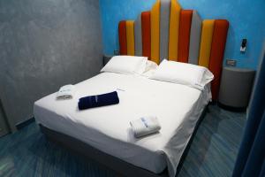 a bedroom with a bed with a colorful headboard at B&B Luca in Marina di Camerota