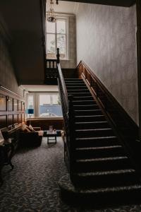 a staircase in a living room with a stair case at The Orwell Hotel in Felixstowe