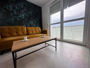 a living room with a couch and a coffee table at Avocado in Wrocław