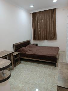 a bedroom with a bed and a table in it at Arev guesthouse Goris in Goris