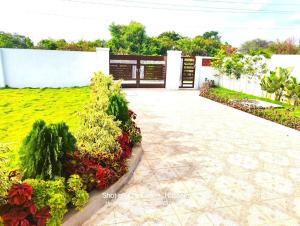 a patio with plants and flowers in a yard at Willow the Villa in Hyderabad