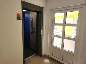 a door in a room with a window at Heviz Victoria apartman in Hévíz