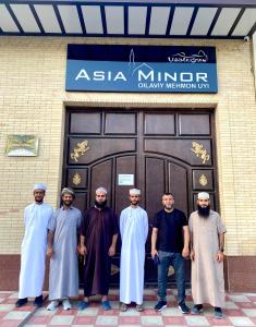 a group of men standing in front of a door at Asia Minor in Samarkand
