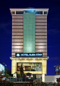 a hotel sulla star building at night at Hotel Suba Star Ahmedabad in Ahmedabad