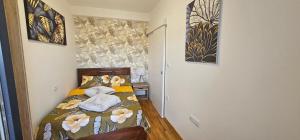 a small bedroom with a bed with flowers on it at Vrnjački Lux free parking GARAGE in Vrnjačka Banja +20 photos