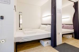 a small room with two bunk beds in it at RadZone Hostel in Singapore