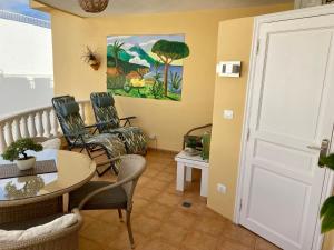 A seating area at Relax and enjoy with a view of El Teide and sea