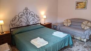 a bedroom with two beds with towels on the bed at Magic Etna and glamorous blue sea in Riposto