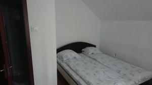 Cama en habitación blanca con colchón en Casa Crăiesei, en Ocna Şugatag