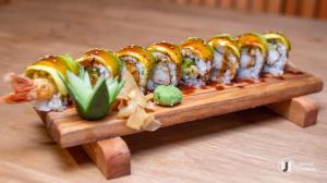 a tray of sushi on top of a wooden table at DISCOVERY COURTS HOTEL in Entebbe