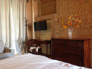 a bedroom with a bed and a dresser and a desk at Agriturismo Da Luca in Calendasco