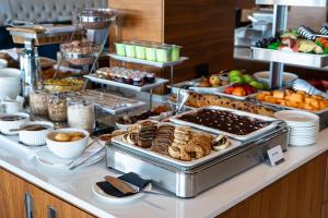 a buffet with a lot of food on a table at Hotel California by Aycon in Sveti Stefan