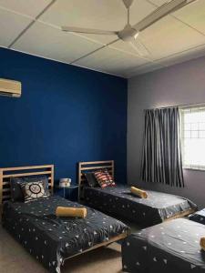 two beds in a room with blue walls at PD BlueBox Bungalow Sailor Theme (Up to 20 Pax) in Port Dickson