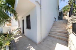 a stairway leading up to a white building with stairs at Villa House Apart Türkbükü in Bodrum City