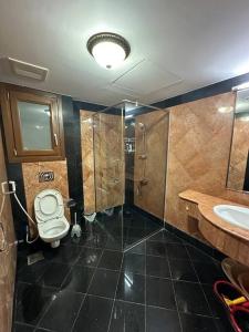 a bathroom with a toilet and a sink at Marina Flat Hawana in Salalah