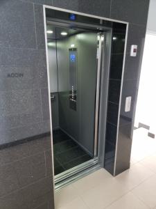 an elevator in a building with a glass door at Apartment Kazimierza Wielkiego in Kętrzyn