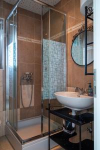 a bathroom with a glass shower and a sink at VDL Apartments in Trogir