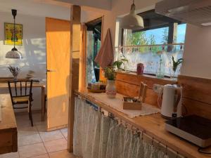 a kitchen with a counter top with a window at Apusenia - darul naturii 