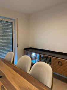 a conference room with chairs and a table and a cabinet at Mira Apart in Bad Säckingen