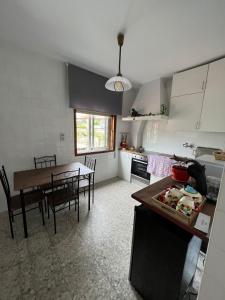 a kitchen and dining room with a table and chairs at A Niñada in Marín