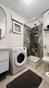 a washing machine in a bathroom with a shower at Casa natura - Olib, gem of islands in Olib +55 photos