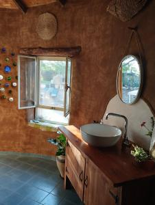 a bathroom with a sink and a mirror at ביתהבוצ - מקום טבעי למפגשים in Talmei Yosef