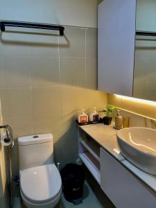a bathroom with a white toilet and a sink at LuxeRN Suite at S Residences in Manila +5 photos