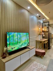a living room with a flat screen tv on a wall at LuxeRN Suite at S Residences in Manila