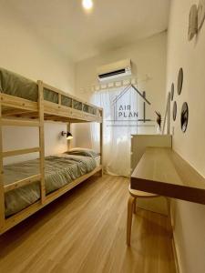 een kamer met 2 stapelbedden en een tafel bij Port Dickson 3BR Cozy Muji Home - 3 Mins to Beach in Port Dickson