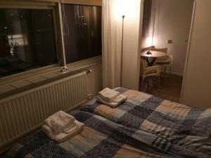 a bedroom with a bed with two pillows on it at Bordine Guesthouse in Leeuwarden