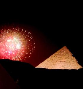 a fireworks display in front of the pyramids at Crystal pyramid inn in Cairo