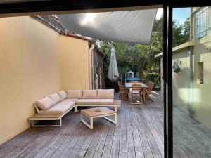 a living room with a couch and a table on a patio at Albi centre ville -piscine view our profile please in Albi