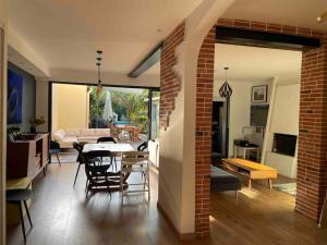 a dining room and living room with a brick wall at Albi centre ville -piscine view our profile please in Albi