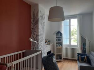 a baby room with a crib and a fireplace at Albi centre ville -piscine view our profile please in Albi