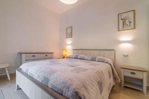 a bedroom with a large bed and two tables at Villa Oleandro in Pula