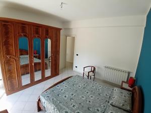 una camera con letto e armadio in legno di Milena CL, Appartamento terzo piano via G Matteotti 9, senza ascensore a Milena